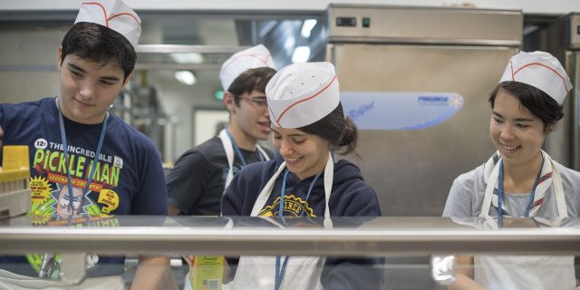 Freiwillige servieren das Essen im großen Restaurant